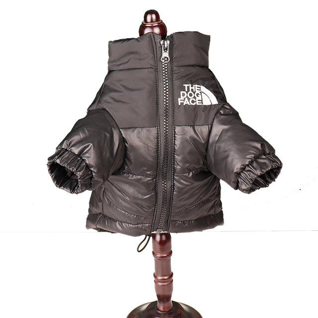 Black dog puffer jacket shown on a display stand, front view with zip and logo detail.