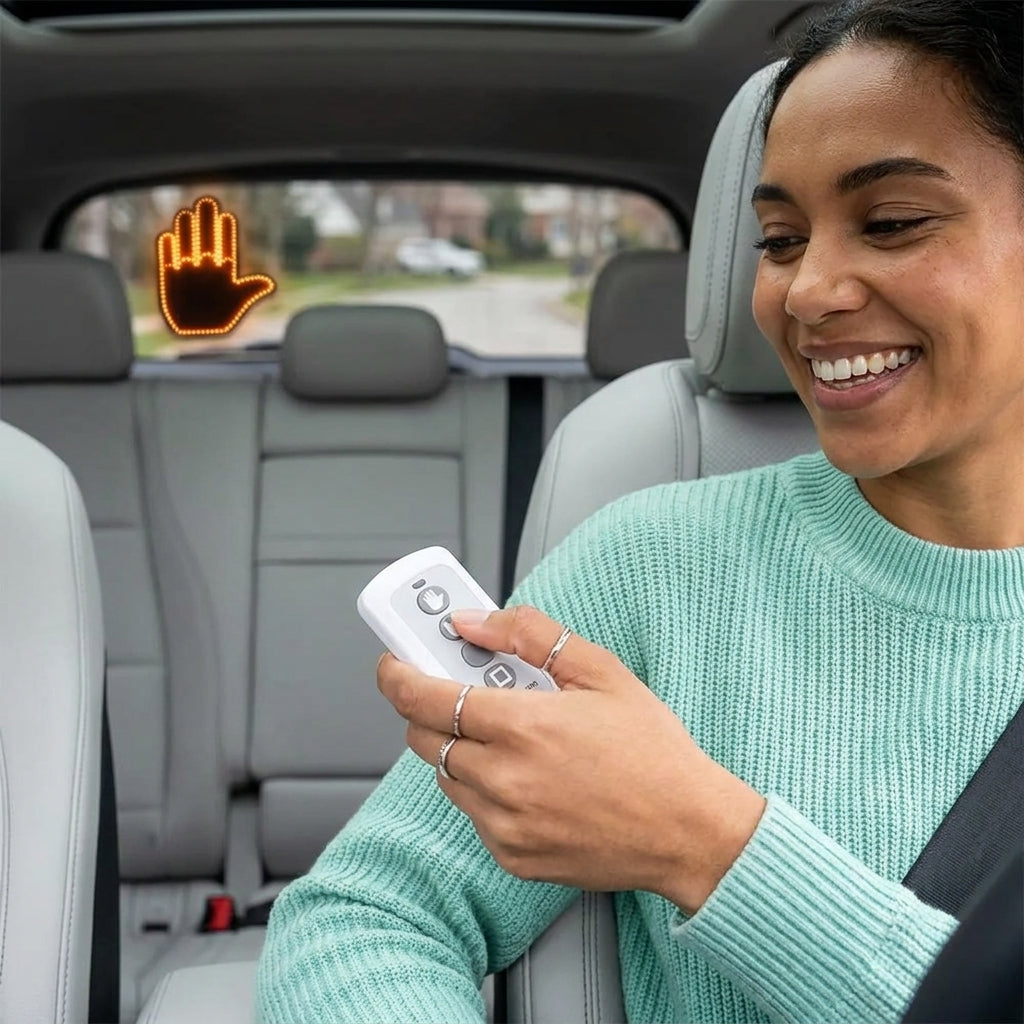 Driver pressing the hand signal for cars remote control while driving, switching between gesture modes without taking eyes off the road.