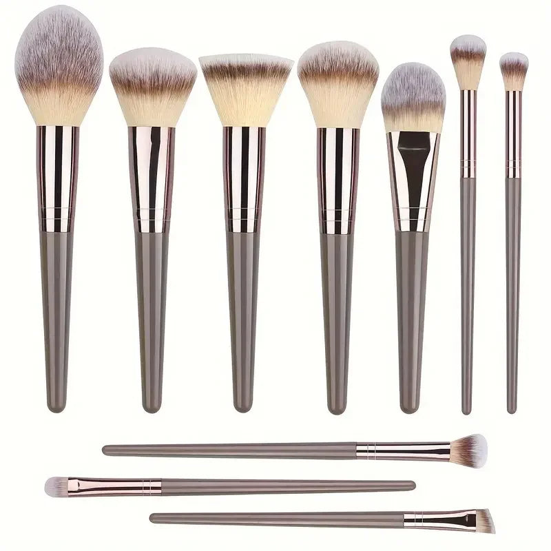 10-piece makeup brushes set flat lay showing the full range including foundation brush, blush brush, fan brush, and precision eye brushes.