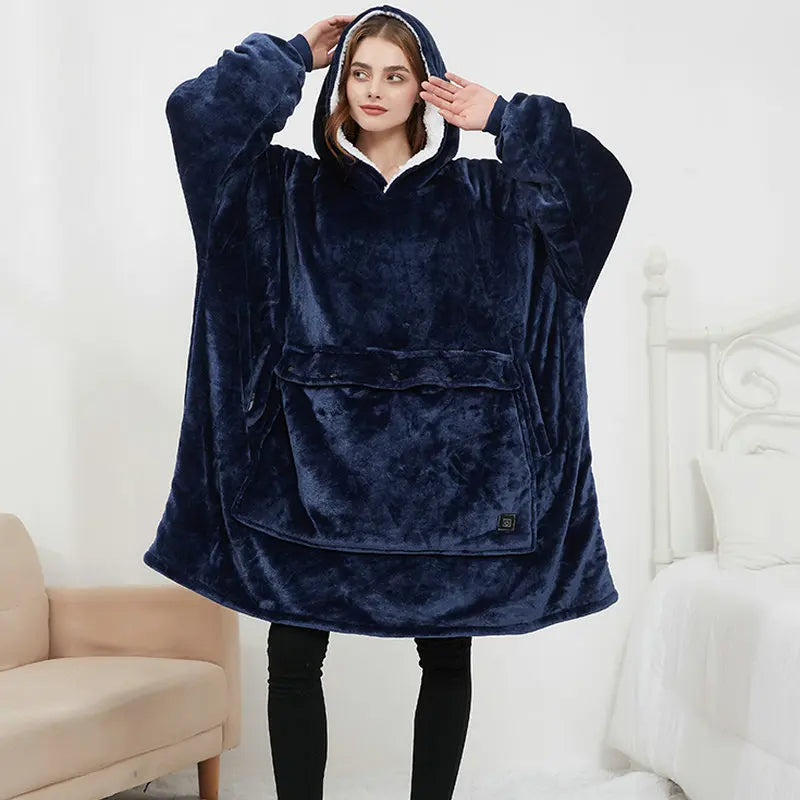 Woman wearing the oversized blanket hoodie in navy blue, showing the full-length wearable blanket design with front pocket.