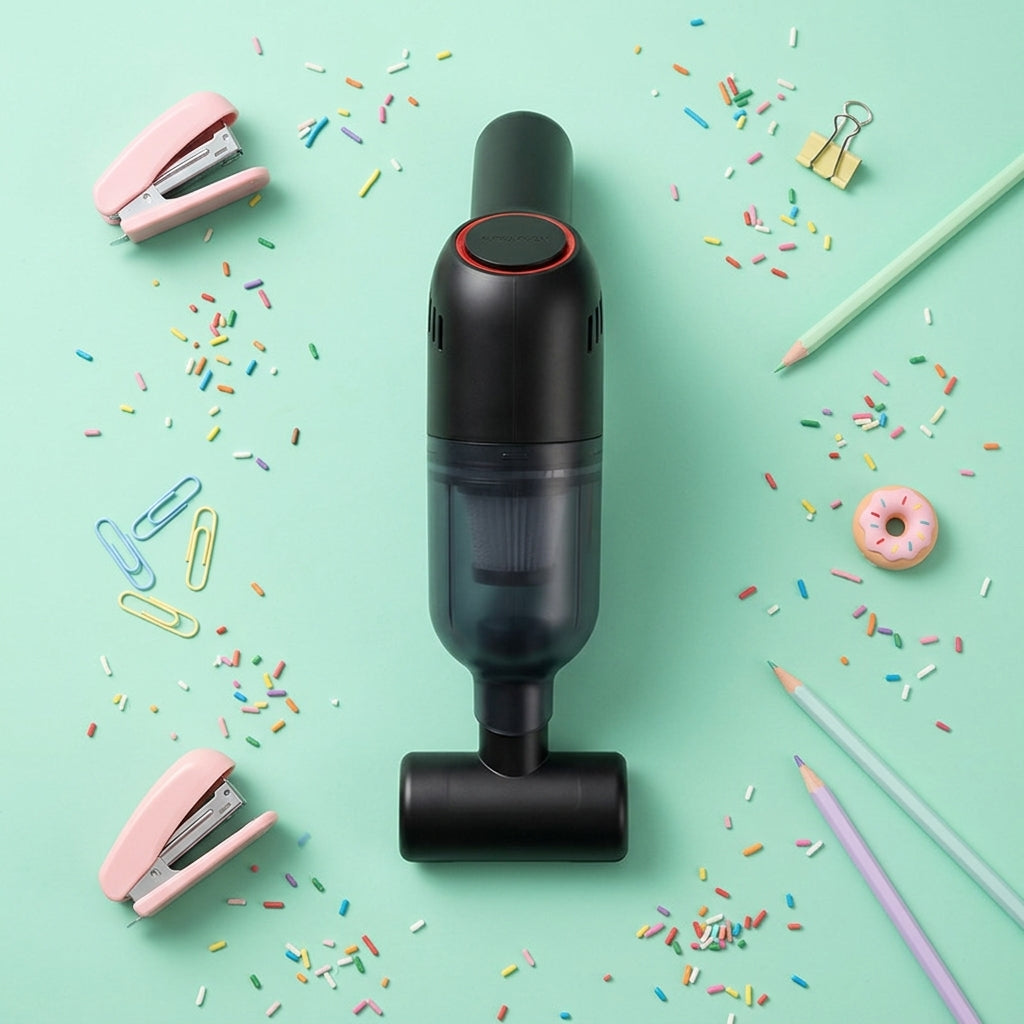 Portable auto vacuum cleaner in black shown with accessories on a bright background, highlighting the compact cordless design.