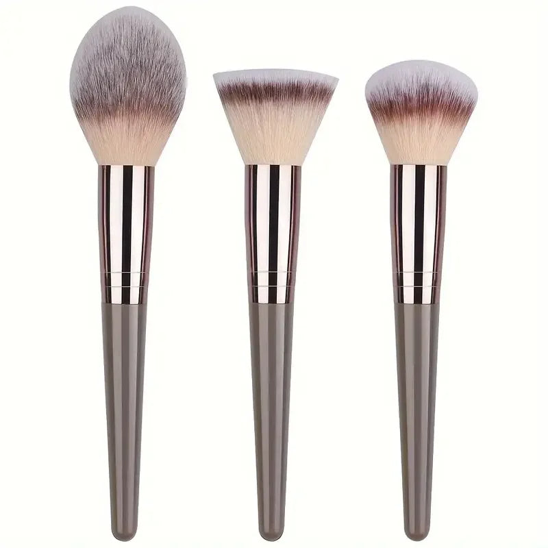 Professional makeup brushes set showing three large fluffy brushes including a foundation brush, powder brush, and blending brush.