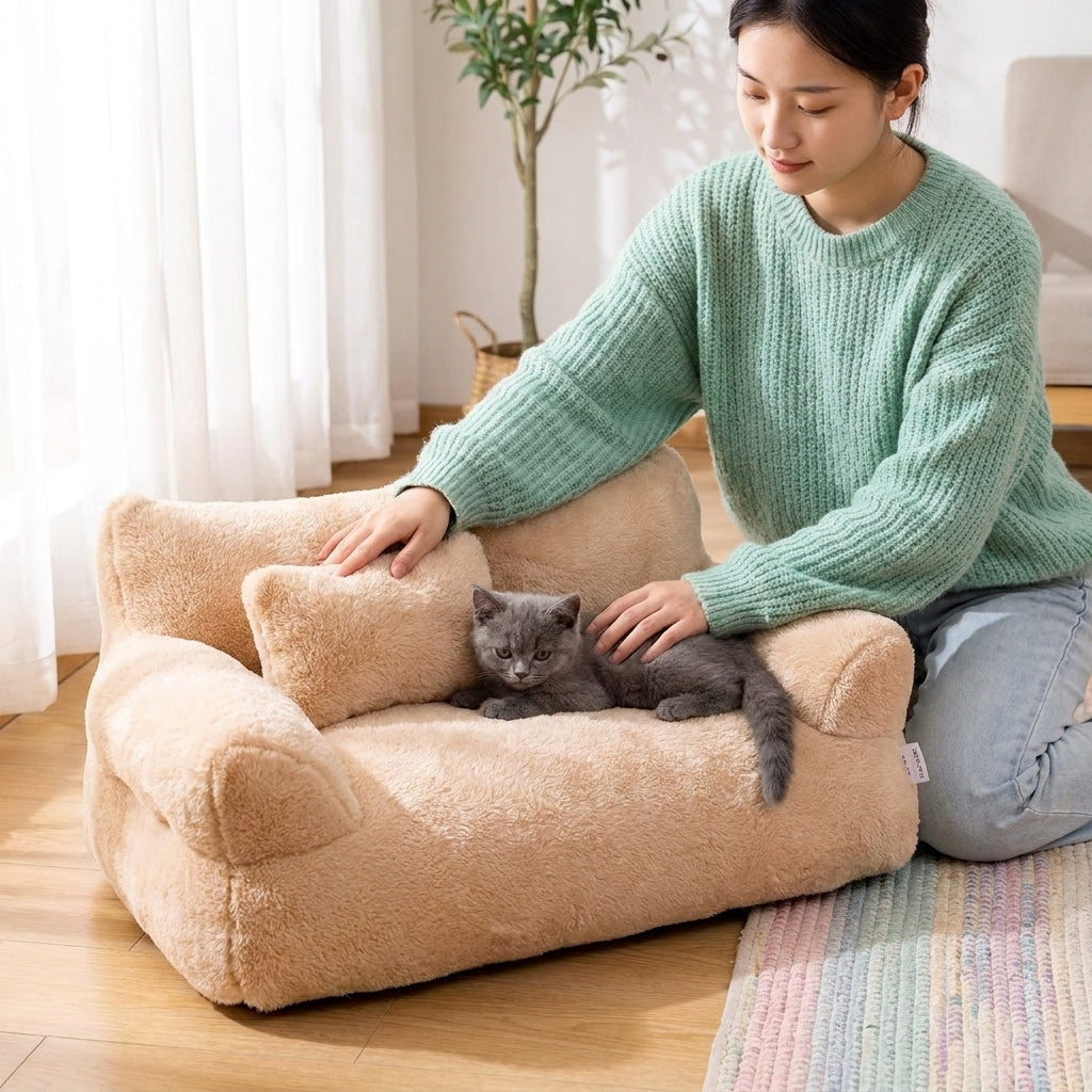 Woman stroking a grey cat lying in the warm cat bed, showing how the plush sofa design encourages cats to settle and relax.