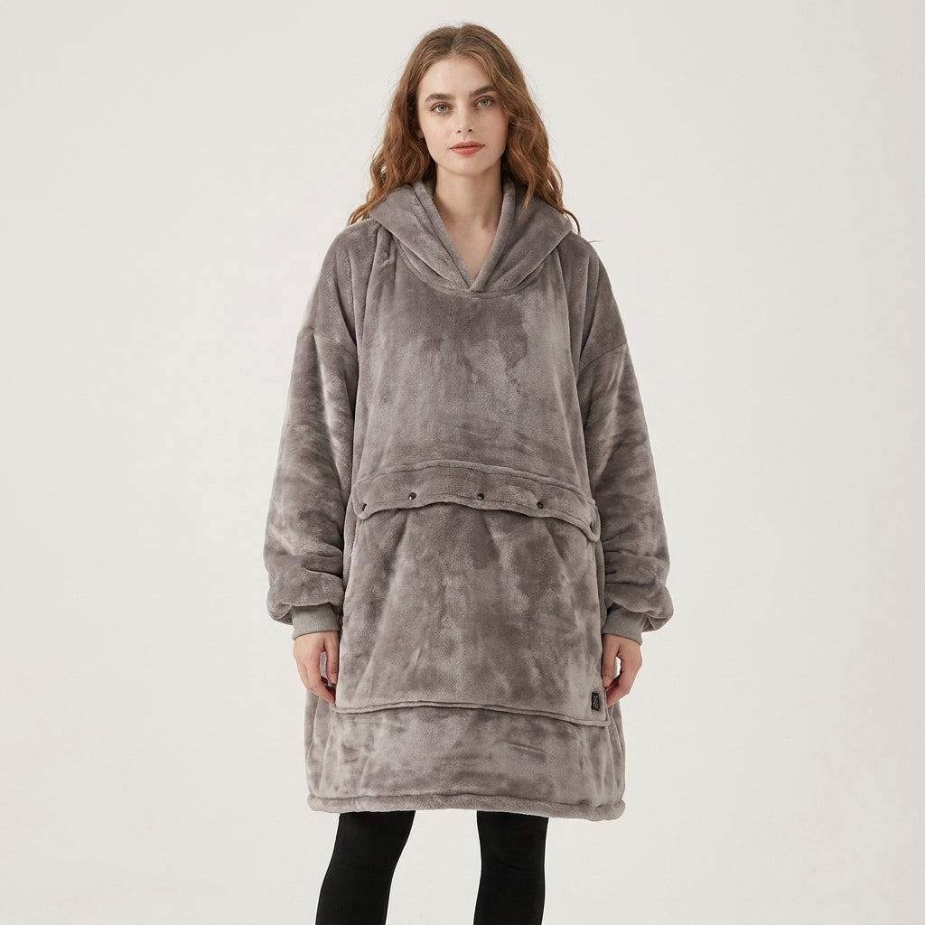 Woman wearing the wearable blanket hoodie at full length, demonstrating the generous oversized fit for men and women.